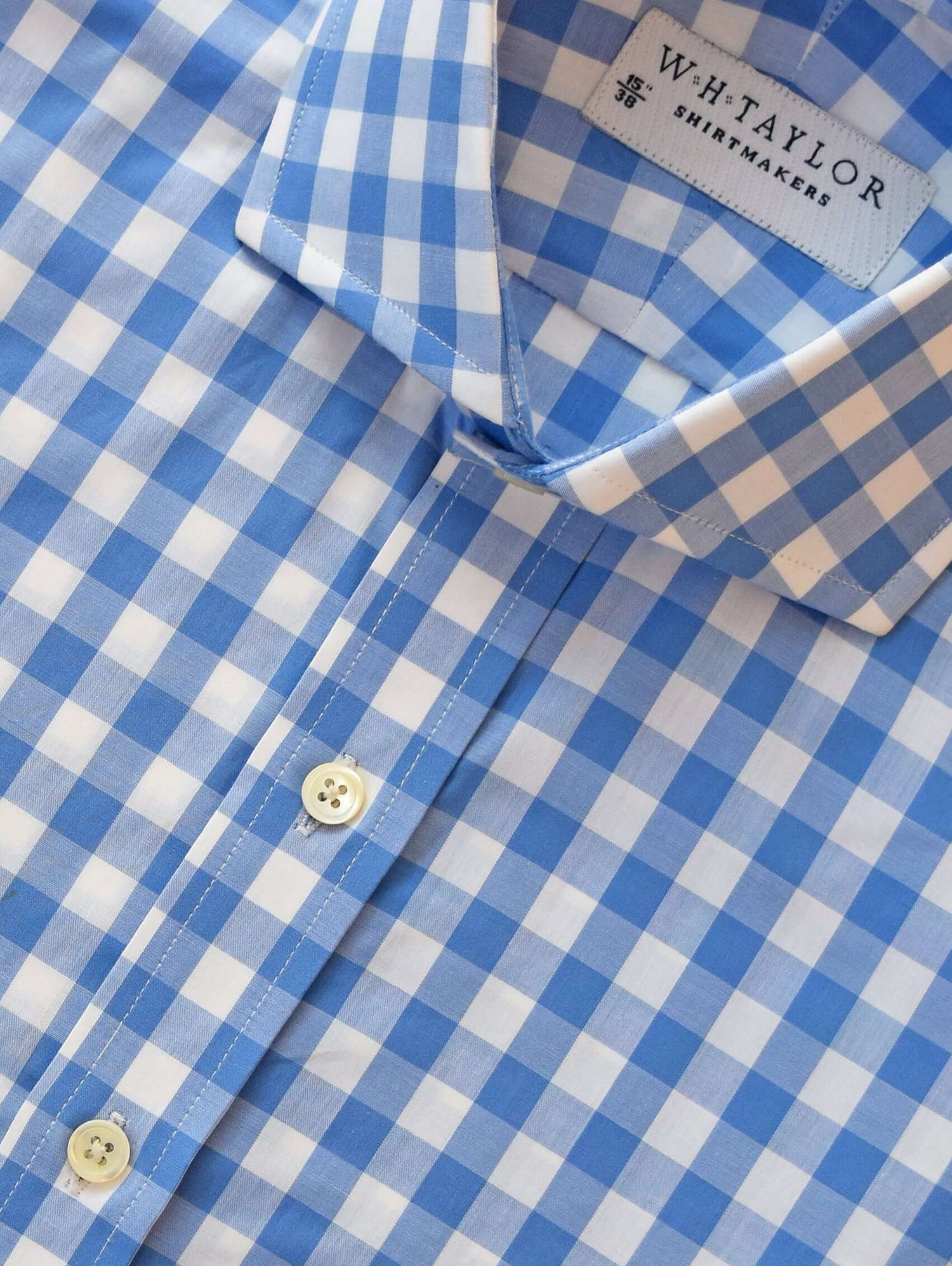 Light blue and white checkered bespoke shirt made from fine 100% cotton fabric, perfect for informal garments.